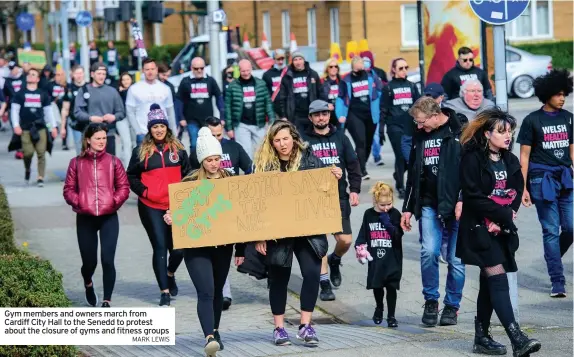  ?? MARK LEWIS ?? Gym members and owners march from Cardiff City Hall to the Senedd to protest about the closure of gyms and fitness groups