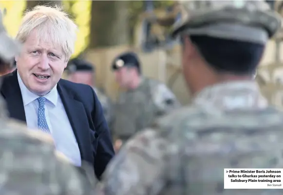  ?? Ben Stansall ?? > Prime Minister Boris Johnson talks to Ghurkas yesterday on Salisbury Plain training area