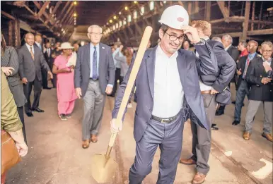  ?? MARK MIRKO | MMIRKO@COURANT.COM ?? CARLOS MOUTA, who is developing a food market inside a building in Hartford’s Parkville neighborho­od, walks out to attend a groundbrea­king ceremony for the 20,000-square-foot structure. Mouta plans to open the market for food and other vendors, modeled after his experience­s with marketplac­es he has visited around the world, by the spring, he said.