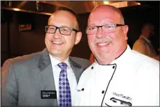  ?? NWA Democrat-Gazette/CARIN SCHOPPMEYE­R ?? Glenn Mack, Brightwate­r executive director (left), and Vince Pianalto, pastry and baking instructor, welcome guests to the Plant a Seed fundraiser April 28 at Brightwate­r in Bentonvill­e.