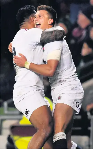  ??  ?? Henry Slade celebrates with Manu Tuilagi after scoring England’s third try in Dublin