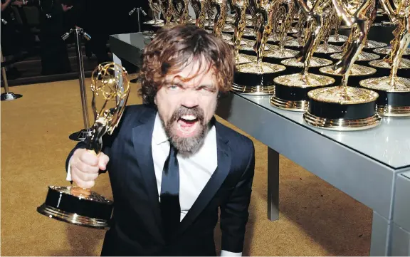  ?? ERIC JAMISON/THE ASSOCIATED PRESS ?? Peter Dinklage enjoys his Emmy for outstandin­g supporting actor in a drama series for Game of Thrones. The fantasy series also won for best drama.