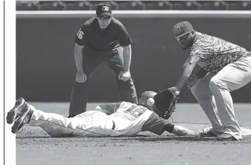  ?? STAFF FILE PHOTO ?? The Chattanoog­a Lookouts’ Ryan Walker makes it safely back to first base as the Tennessee Smokies’ Yasiel Balaguert tries to pick him off in a game last season at AT&T Field.