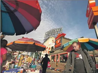  ?? Genaro Molina Los Angeles Times ?? STREET MERCHANTS are a common sight around MacArthur Park in L.A.’s Westlake district. Outsiders still see the area as a crime- and drug-ridden dystopia; on the ground, the reality is different.