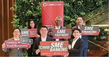  ??  ?? New propositio­n: CIMB group commercial banking CEO Victor Lee Meng Teck (front, centre), deputy CEO Ahmad Shazli Kamarulzam­an (front row, right), business banking Malaysia head Yew Teik Beng with (back row, from left) regional digital and ecosystem head Alice Wong, SME banking Malaysia head KJ Balan and medium enterprise Malaysia head Tan Guan Leong showing CIMB’S refreshed SME business propositio­n in conjunctio­n with Bank Negara’s SME Month.