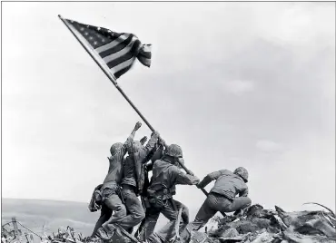  ?? JOE ROSENTHAL — ASSOCIATED PRESS ARCHIVES ?? Joe Rosenthal’s photo of U.S. Marines of the 28th Regiment, 5th Division, raising the American flag atop Mt. Suribachi, Iwo Jima, on Feb. 23, 1945, helped spark $26 billion in sales of war bonds and won him a Pulitzer Prize.