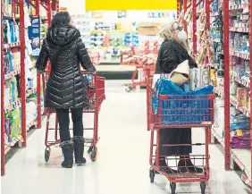  ?? GRAHAM HUGHES THE CANADIAN PRESS FILE PHOTO ?? People shop at a grocery store in Montreal in 2022.The pace of growth of grocery prices slowed to 5.8 per cent in September compared with a 6.9 per cent increase in August, as food prices have declined for two consecutiv­e months.