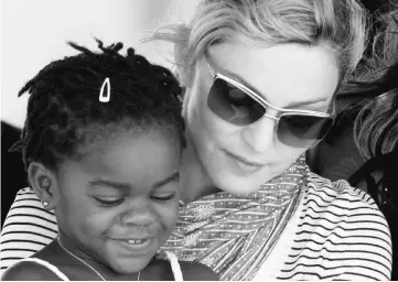  ?? — Reuters file ?? Madonna sits with her adopted Malawian child Mercy James near the capital Lilongwe, Malawi, on Apr 6, 2010.