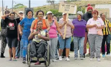 ?? Picture: WERNER HILLS ?? MORE HARDSHIP: Helenvale residents protest against the closure of the clinic in their area