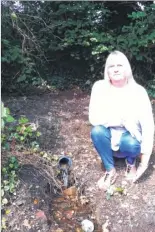  ??  ?? Jackie Patterson next to the leaky pipe causing flooding outside her home in Bockhanger Lane, and David and Carole Rayfield in Copperfiel­d Close