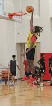  ?? ?? At 6-4, Trenarius Brooks dunks the ball during a recent Jacksonvil­le Titans practice. Coach Victor Joyner said Brooks is “explosive off the bounce.”