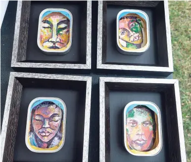  ??  ?? Paintings on sardine cans by Alfonso Blake.