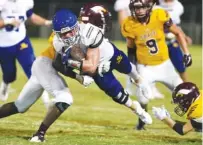  ?? STAFF FILE PHOTO BY ROBIN RUDD ?? Boyd-Buchanan’s Kohl Henke goes airborne as he is hit by Grace’s Adam Echols during their Sept. 22 game at Grace.