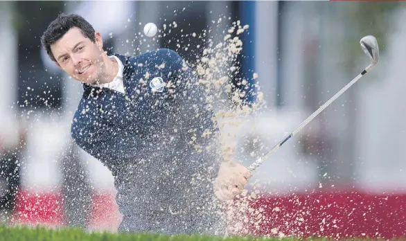  ?? JIM WATSON/AFP/GETTY IMAGES ?? Rory McIlroy of Northern Ireland hits from a bunker during a practice round Tuesday in advance of the Ryder Cup at Hazeltine National Golf Club in Chaska, Minn. The 27-year-old is coming off a victory that netted him more than $10 million last weekend.