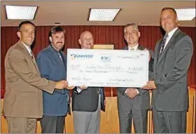  ?? Submitted photo ?? Univest Corp. Senior Executive Vice President Kenneth Hochstetle­r, second from right, and Univest Corp. Senior Executive Vice President and CFO Jeffrey Schweitzer, right, present a $100,000 check to, from left, Souderton Borough Council President Brian...