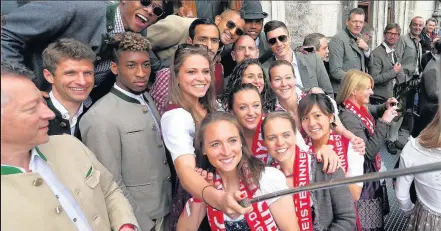  ??  ?? CHAMPIONS AT THE DOUBLE Bayern Munich men’s and women’s teams celebrate their league title success on the town hall balcony