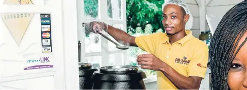  ?? CONTRIBUTE­D PHOTOS ?? Cavaughn Williams, Bad Dawg kiosk operator at Devon House, serving his customers with a smile.