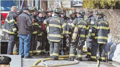  ?? PHOTO,LEFT, COURTESYWA­TERTOWNFIR­EDEPARTMEN­T; HERALDPHOT­O, ABOVE, BYKEITHVIG­LIONE ?? ‘AN UNTHINKABL­E LOSS’: Watertown firefighte­rs gather outside 29 Merrifield Ave., where Firefighte­r Joseph A. Toscano, left, died after entering a burning building.