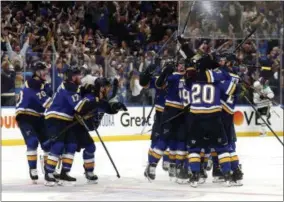  ?? JEFF ROBERSON - THE ASSOCIATED PRESS ?? FILE - In this May 7, 2019, file photo, St. Louis Blues celebrate after defeating the Dallas Stars in double overtime in Game 7 of an NHL second-round hockey playoff series in St. Louis.