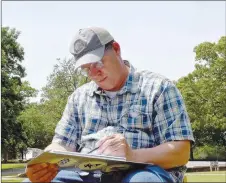  ?? JOHNAN MITCHELL SPECIAL TO ENTERPRISE-LEADER ?? Jim Mullenax is a nature journalist and records his art subjects on sketchpads. Here, he is nature journaling at Prairie Grove Battlefiel­d State Park. His sketchpads have animals and trees but lots of other subjects, such as trash cans, people and cars.