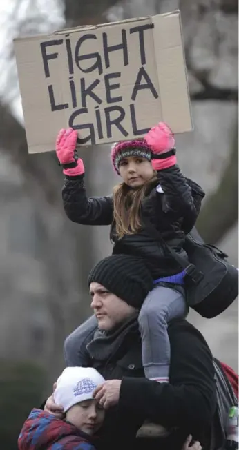  ?? JIM RANKIN/TORONTO STAR ?? Willow Wilkinson, 7, sits on her father Jordan Wilkinson’s shoulders, with brother Rowan, 9, at Queen’s Park.