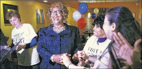  ?? CHRISTIAN GOODEN / ST. LOUIS POST-DISPATCH ?? Ella Jones (center) thanks supporters after learning she won the Ward 1 seat Tuesday at her election party at Drake’s Place in Ferguson. Half of the city’s six-member council is now African-American.