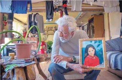  ?? EDDIE MOORE/JOURNAL ?? Antonio DeVargas, at his home in Servilleta north of Ojo Caliente, shows a picture of his daughter Carmela as a young girl. He says she was mistreated by Santa Fe County jail personnel while she suffered from meningitis before her death on Nov. 9.