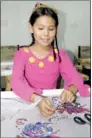  ?? ZHANG HONGCHI / XINHUA ?? A Uygur girl learns embroideri­ng at a traditiona­l Uygur embroidery workshop in Hami, the Xinjiang Uygur autonomous region.