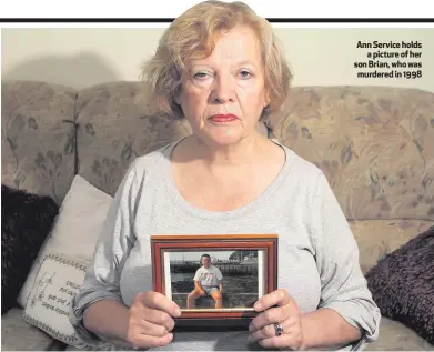  ??  ?? Ann Service holds
a picture of her son Brian, who was murdered in 1998