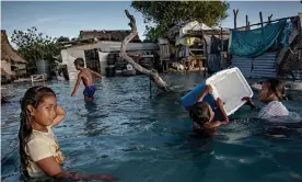  ??  ?? The people of Kiribati are under pressure to relocate due to sea-level rise. Flooding in the village of Eita on the Tarawa atoll is increasing­ly frequent. Photograph: Jonas Gratzer/LightRocke­t via Getty Images