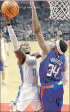  ?? Kevork Djansezian Getty Images ?? TOBIAS HARRIS blocks a shot by Dennis Schroder of the Thunder at Staples Center.