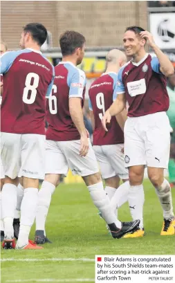  ?? PETER TALBOT ?? Blair Adams is congratula­ted by his South Shields team-mates after scoring a hat-trick against Garforth Town