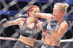  ?? AP FILE ?? Holly Holm, right, and Cris Cyborg could be in line for a rematch later this year pending the result of Holm’s fight against Megan Anderson in June.