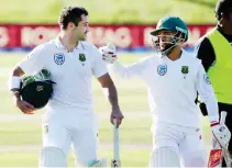  ??  ?? South Africa's Dean Elgar, left, is congratula­ted by teammate Temba Bavuma after scoring 128 not out as they leave the field following the first day's play of the first cricket Test against New Zealand at University Oval, Dunedin, New Zealand,...