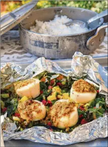  ?? STYLING BY WENDELL BROCK/CHRIS HUNT FOR THE AJC ?? Atlanta native Eric Kim’s foil-wrapped scallops, dotted with caperraisi­n butter and steamed on a mound of rainbow-chard ribbons, are easy and luxurious.