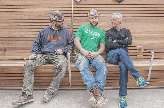  ?? RICH HEIN/ SUN- TIMES FILE ?? Mayor Rahm Emanuel sits with iron workers while touring a section of the Chicago Riverwalk in 2015.