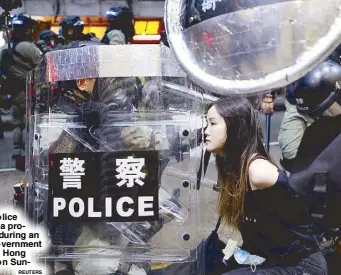  ?? REUTERS ?? Riot police detain a protester during an anti-government rally in Hong Kong on Sunday.