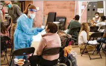  ?? REBECCA NOBLE/NEW YORK TIMES ?? Ally Ramona performs a COVID-19 test at Casa Alitas, a shelter for migrant families in Tucson, Arizona, on April 15. The Border Patrol says it has insufficie­nt time and space to conduct coronaviru­s testing at crowded processing stations.