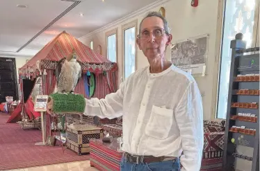  ?? PROVIDED BY ED STEGER ?? Ed Steger has been able to live a full life after surgery despite treatment that made it difficult for him to speak. He’s pictured during a trip last year, holding a falcon at a mosque visitor center in Dubai.