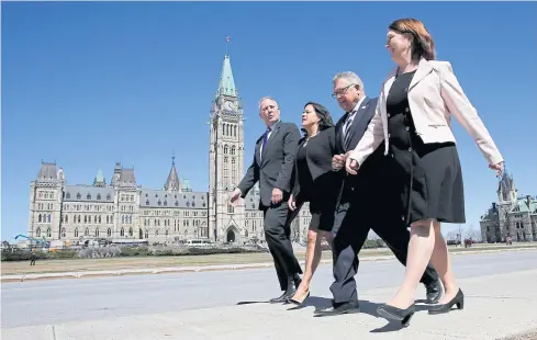  ??  ?? BLAZING THE TRAIL: Members of Canadian Prime Minister Justin Trudeau’s cabinet assigned to the legalised marijuana file walk on Parliament Hill in Ottawa, Ontario, on Thursday.