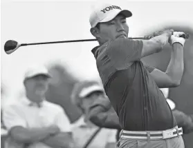  ?? AP ?? Sung Kang watches his tee shot on the third hole during Saturday’s third round of the Houston Open in Humble, Texas. He shot a 1-under 71 for a three-stroke lead.