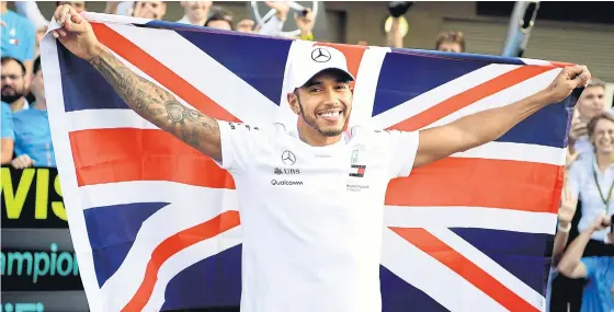  ??  ?? Mercedes’ Lewis Hamilton celebrates winning his fifth world championsh­ip after the Mexico Grand Prix last month.