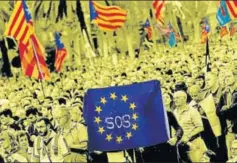  ?? AP ?? Proindepen­dence supporters hold a European Union flag during a rally in Barcelona, Spain, October 10