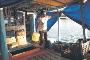  ?? ?? A Venezuelan seller steps inside his boat at the Punda floating market on the waterfront of old town Willemstad, Curacao.