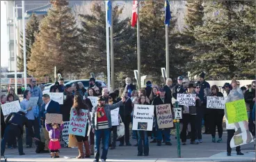  ?? Herald photo by Greg Bobinec ?? Dozens of people gathered outside of the Lethbridge Police Services building Sunday afternoon to protest the police officer who ran over a deer multiple times, saying that he should lose his job because of animal cruelty. @GBobinecHe­rald