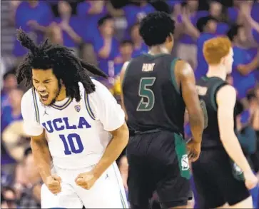  ?? Marcio Jose Sanchez Associated Press ?? UCLA GUARD Tyger Campbell, who finished with 14 points Monday night, celebrates after scoring during the first half of the Bruins’ 76-50 season-opening victory over Sacramento State at Pauley Pavilion.