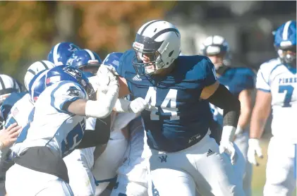  ?? BILL UHRICH/READING EAGLE ?? Wyomissing’s Caleb Brewer blocks a Lampeter-Strasburg player last fall at the A Field.