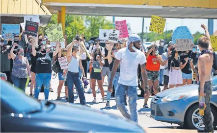 ?? [BRYAN TERRY/ THE OKLAHOMAN] ?? Protesters hold their arms in the air during a Black Lives Matter rally in Oklahoma City on Sunday.