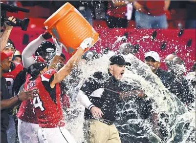  ?? JOHN DAVID MERCER-USA TODAY SPORTS ?? Atlanta Falcons players give coach Dan Quinn a celebrator­y soaking following their 44-21 victory over the Green Bay Packers in Sunday’s NFC championsh­ip game at Atlanta’s Georgia Dome. The Falcons will face the New England Patriots in Super Bowl LI in...