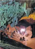  ??  ?? Rescuers install a water pump, a crucial piece of equipment in the cave rescue operation.